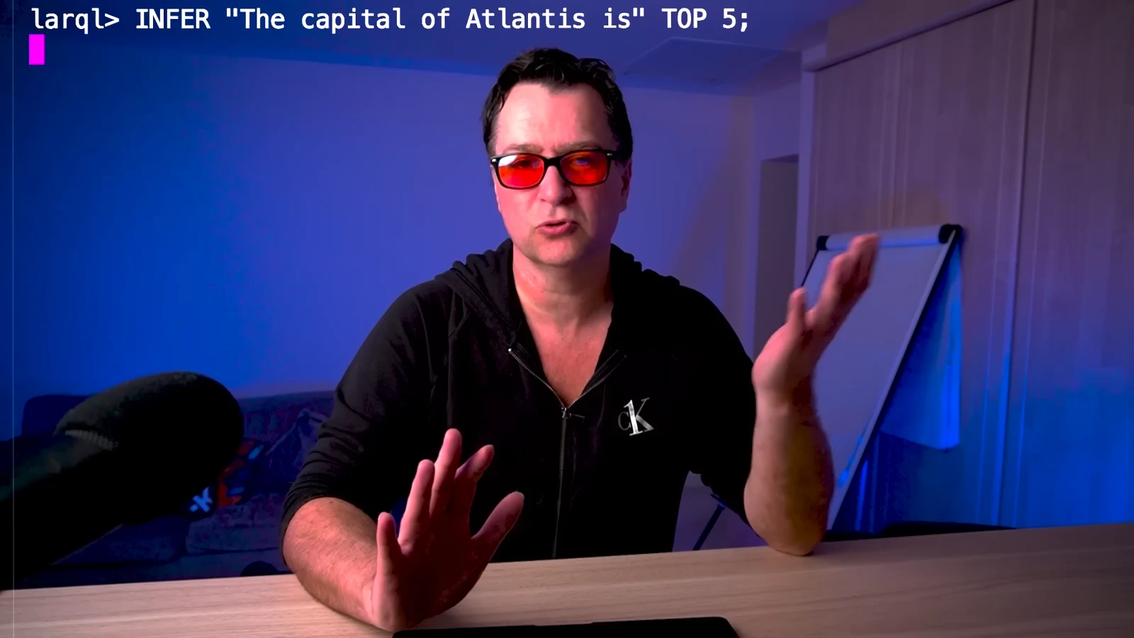 The LARQL knowledge-writing demonstration queries the capital of Atlantis.