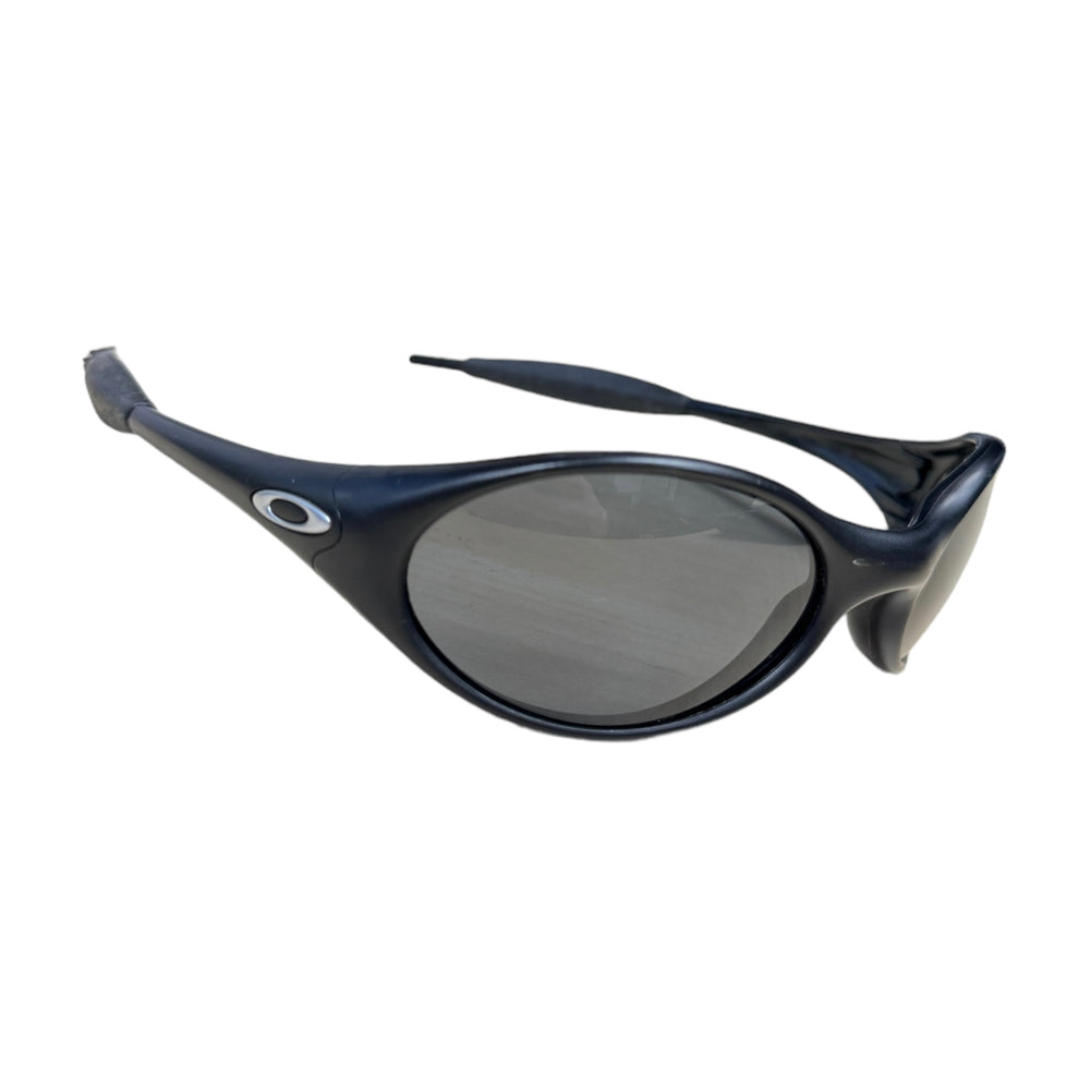 Reference black Oakley Eye Jacket frames with curved oval lenses.